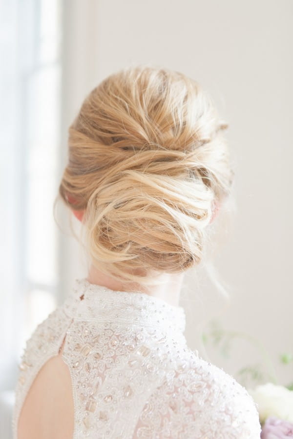 Tousled low bun wedding hairstyle