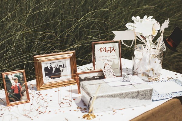 Copper framed pictures on wedding guest book table