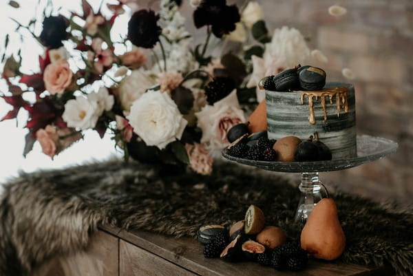 Grey wedding cake decorated with autumn fruits