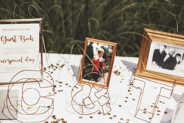 Copper wire initials on wedding guest book table