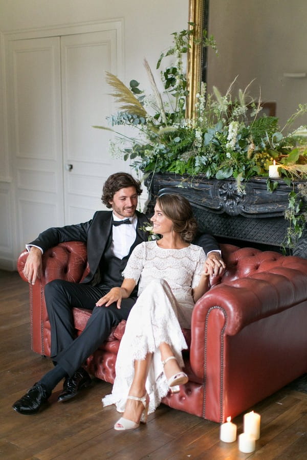 Bride and groom sitting on couch at Chateau de Redon