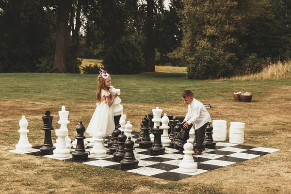 Children playing giant chess at wedding