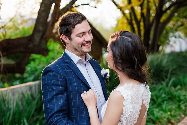 Groom smiling at bride