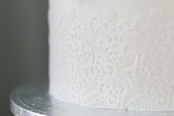 Lace iced detail on white wedding cake