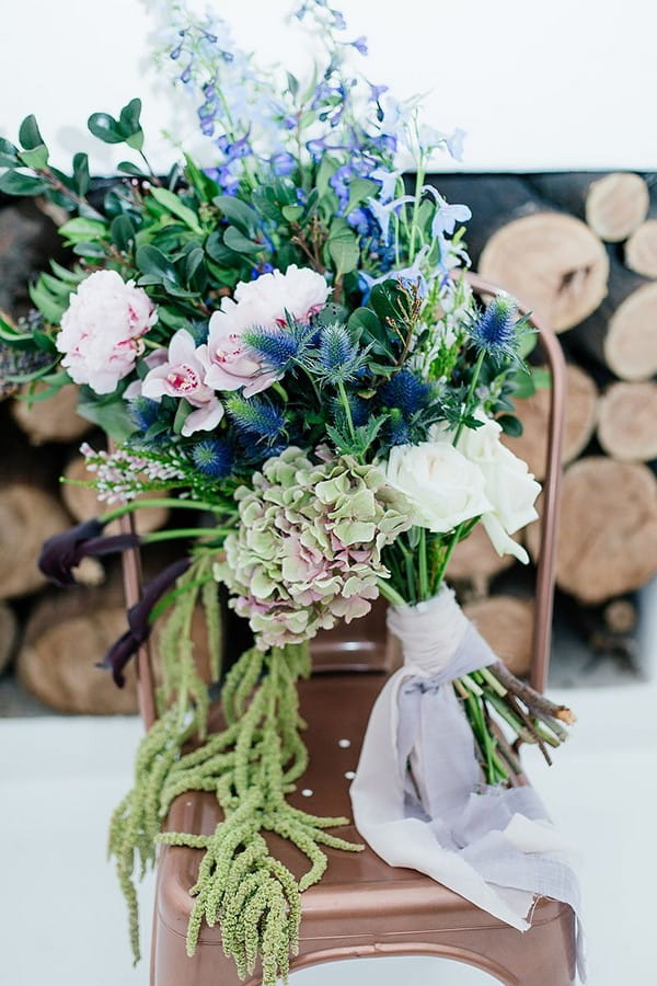 Large winter wedding bouquet on copper chair