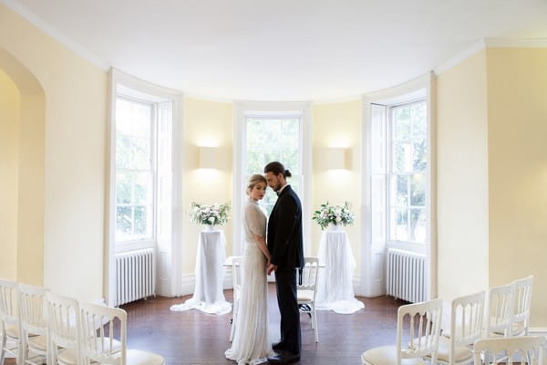 Bride and groom in wedding ceremony room at Clissold House