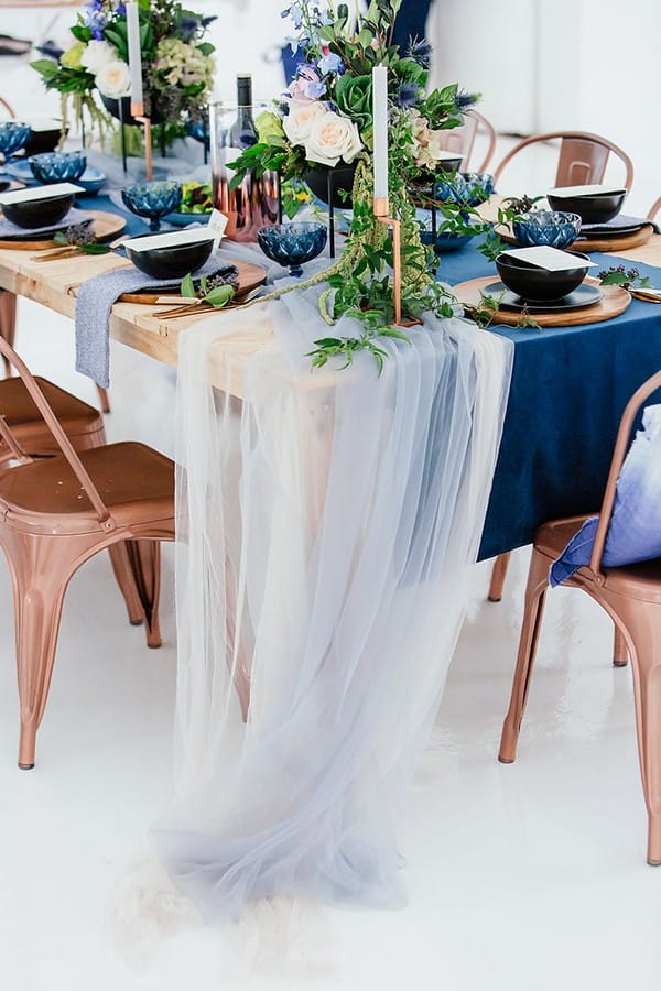 Tulle hanging from wedding table