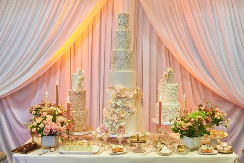 Three Wedding Cakes with Varying Tiers on Table