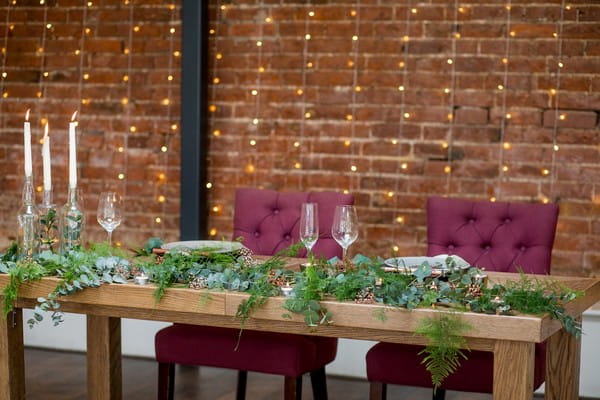 Wooden wedding table with foliage table runner