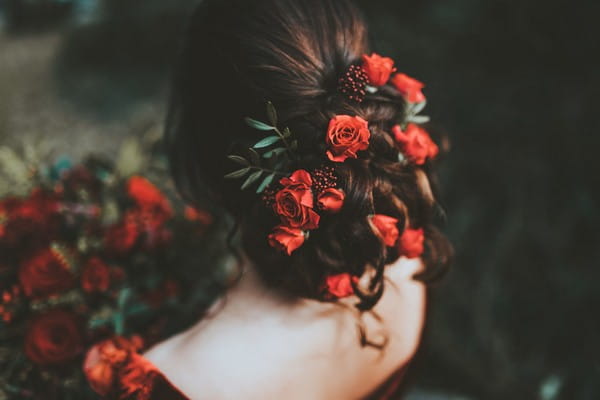 Red flowers in bride's hair