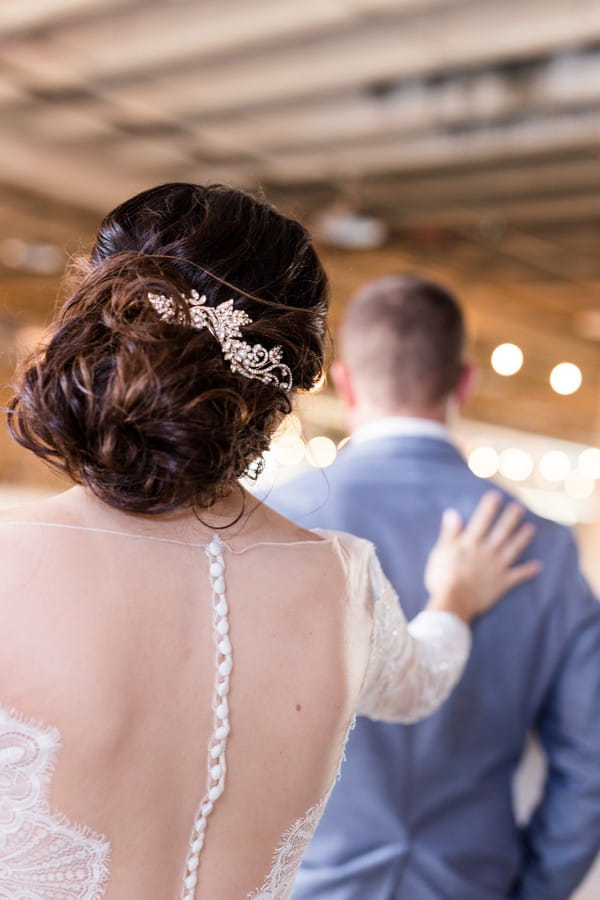 Bride touching groom on shoulder from behind