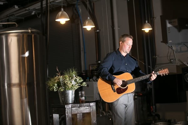 Guitarist playing at brewery wedding