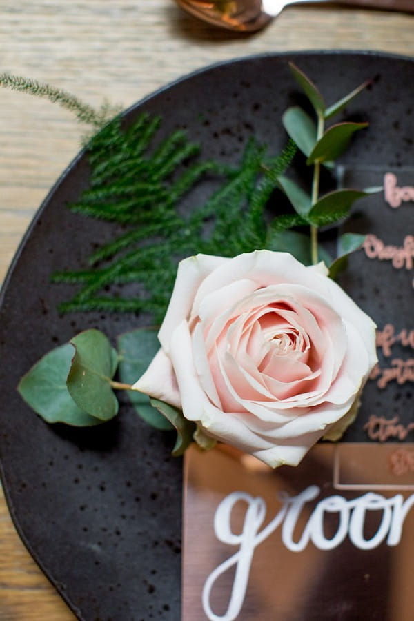 Pink rose and foliage on wedding plate