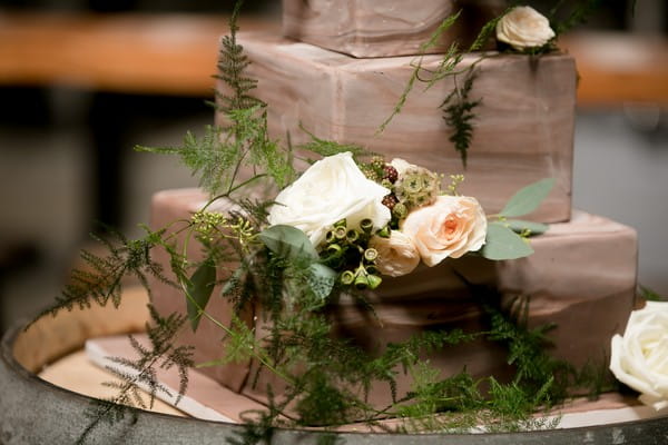 Fresh flowers on brown ombre wedding cake