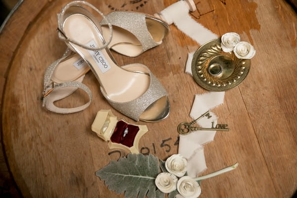 Jimmy Choo silver wedding shoes on beer barrel