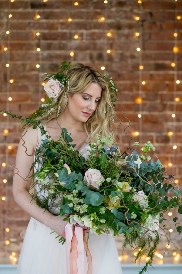 Bride holding foliage bouquet with foliage crown