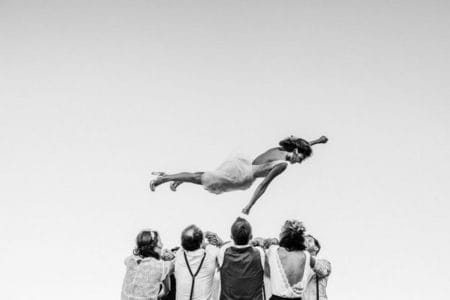 Bridal party throwing bride into the air - Picture by Alison Bounce Photography