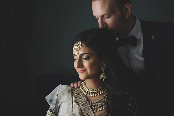 Groom kissing back of Indian bride's head - Picture by Rik Pennington Photography