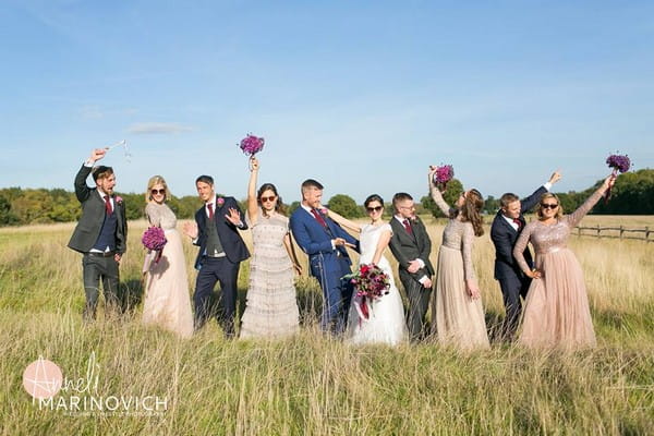 Bridal party posing in field for photograph - Picture by Anneli Marinovich Photography