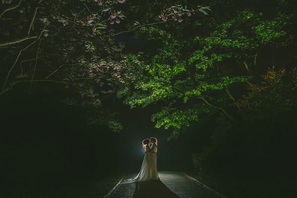 Brides kissing under tree at night - Picture by Nik Bryant Photography