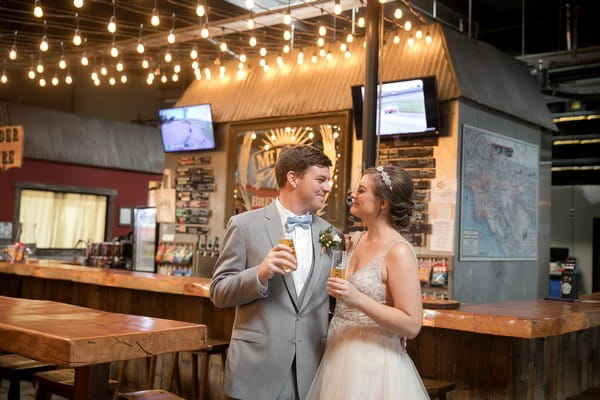 Bride and groom by bar in Mt. Lowe Brewery