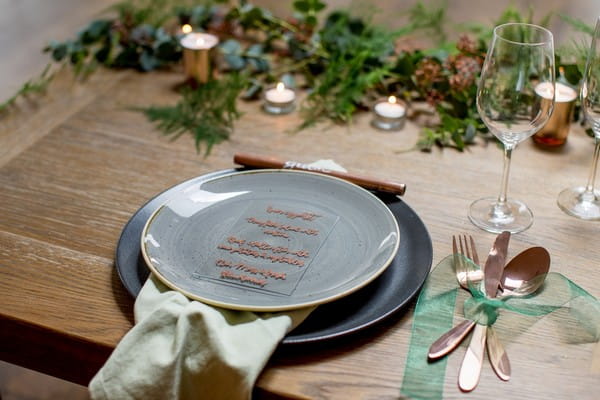 Grey wedding plate with glass menu and copper details