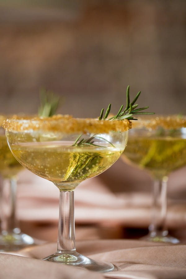 Copper coloured drink with rosemary