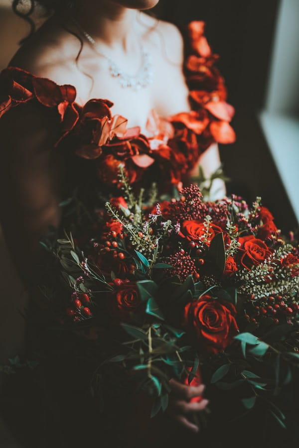 Bride holding red bridal bouquet