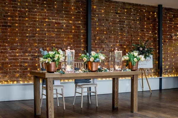 Table with foliage and copper wedding styling