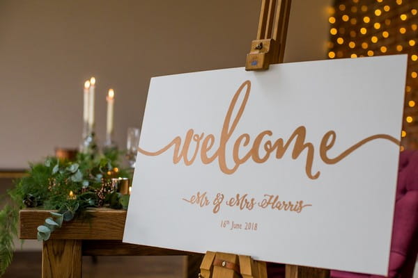 Copper wedding welcome sign on easel