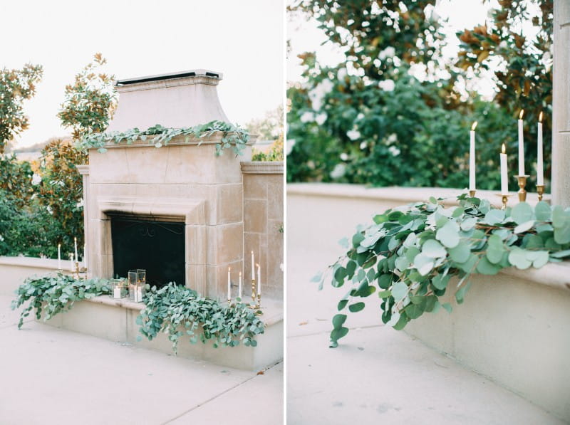 Outdoor fireplace styled with eucalyptus leaves