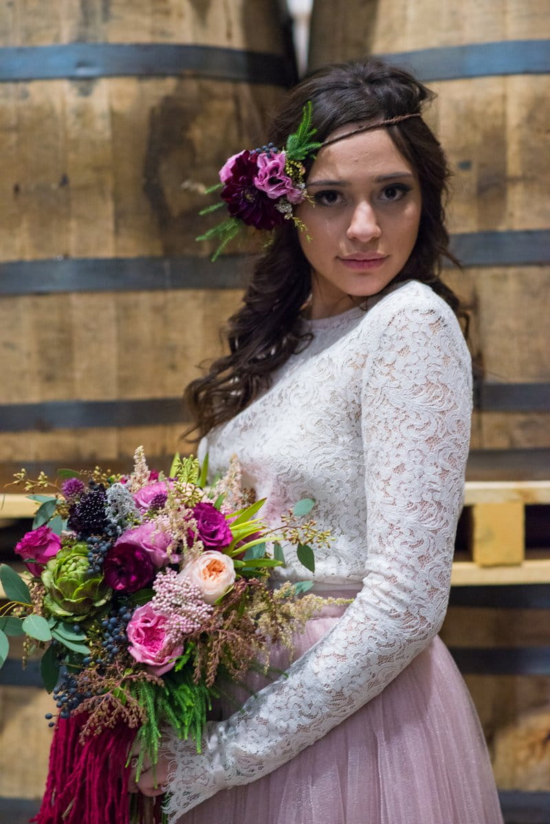 Bride with flowers in her hair holding bouquet