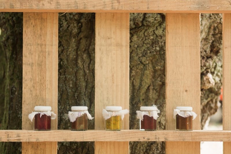 Small jars of preserves on wooden pallet