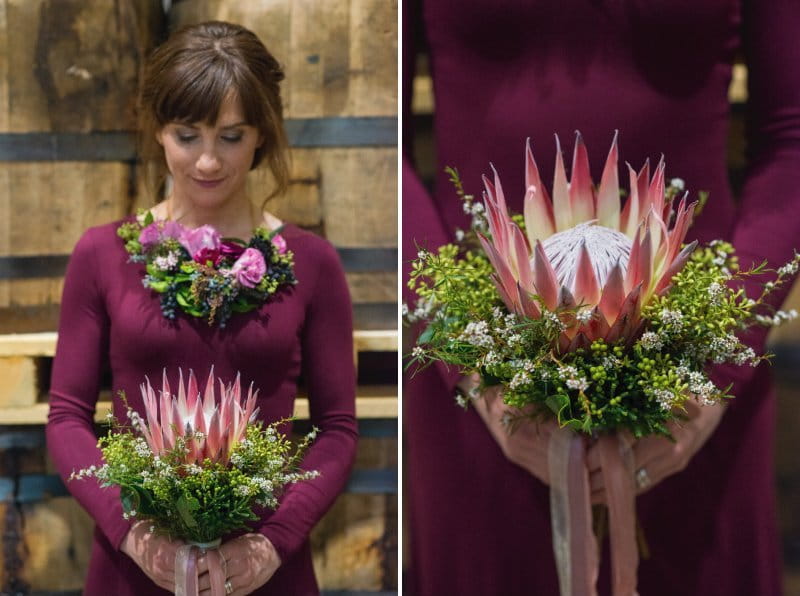 Bridesmaid with flowers around her neck holding bouquet