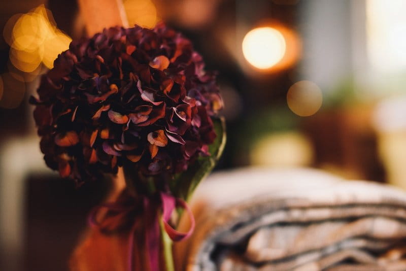 Purple hydrangea pomander tied to chair