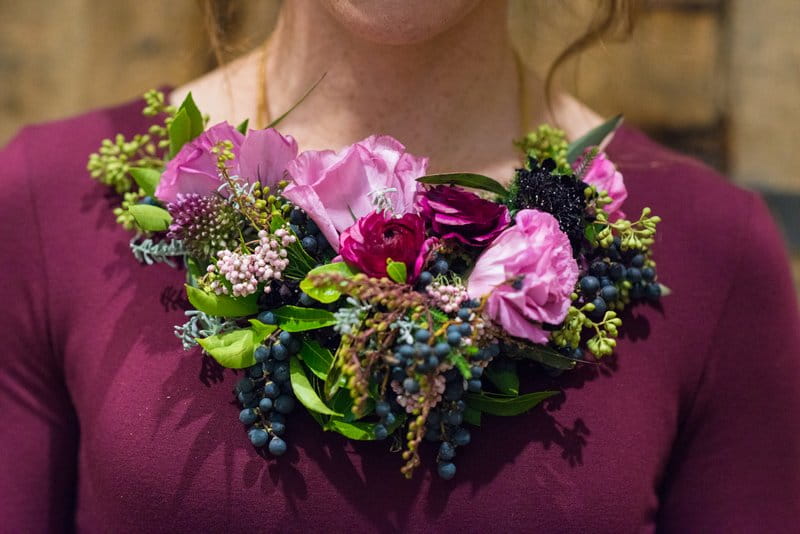 Flowers around bridesmaid's neck