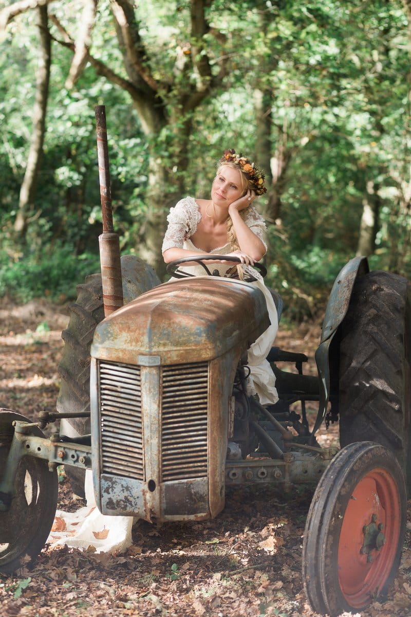 Bride sitting on old tractor