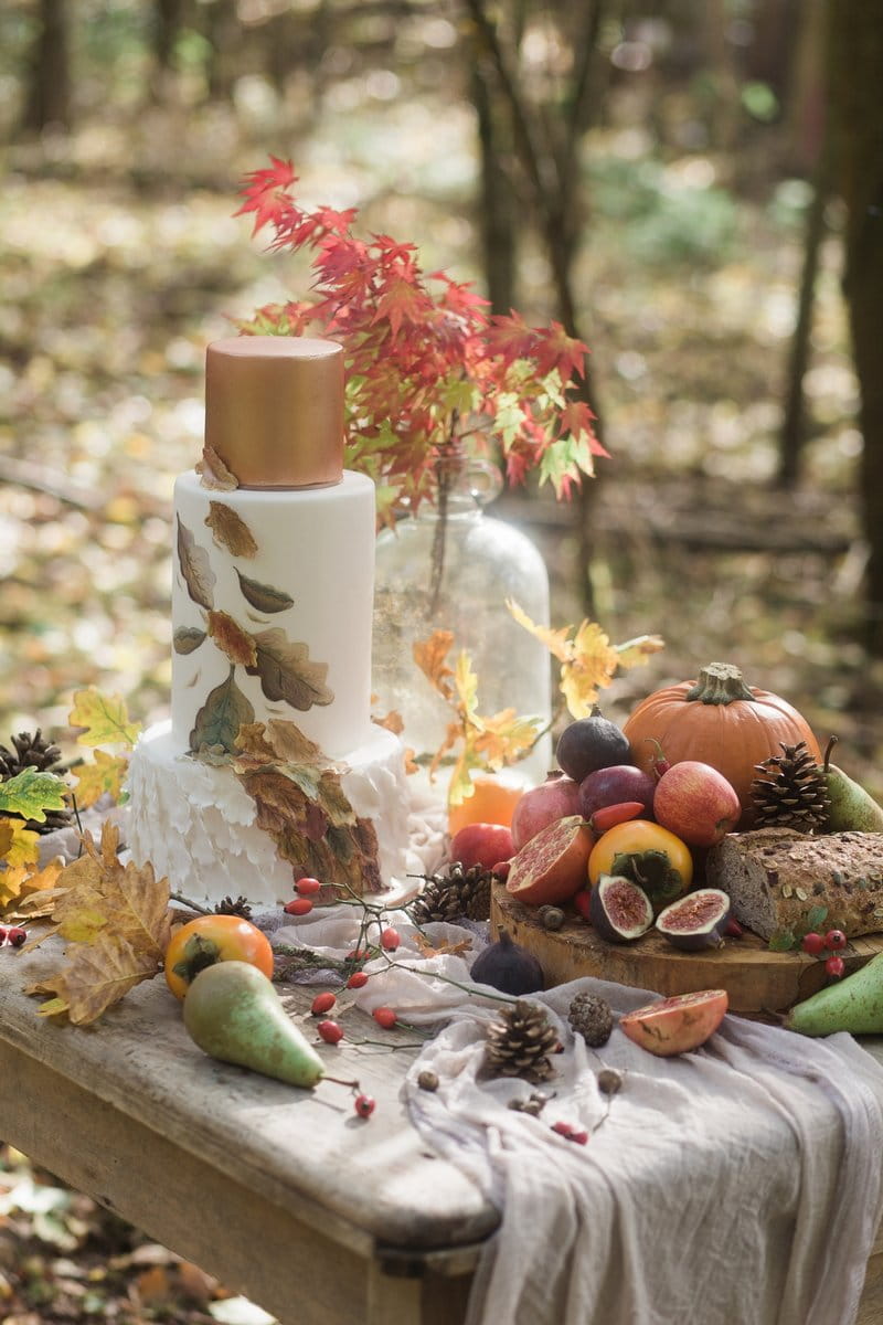 Autumn wedding cake and fruit and vegetables on table