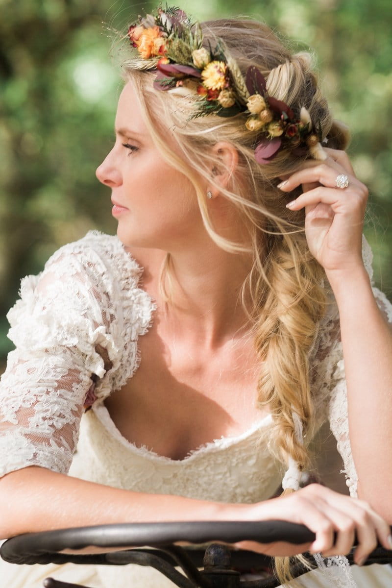 Bride with plait hairstyle wearing autumn flower crown