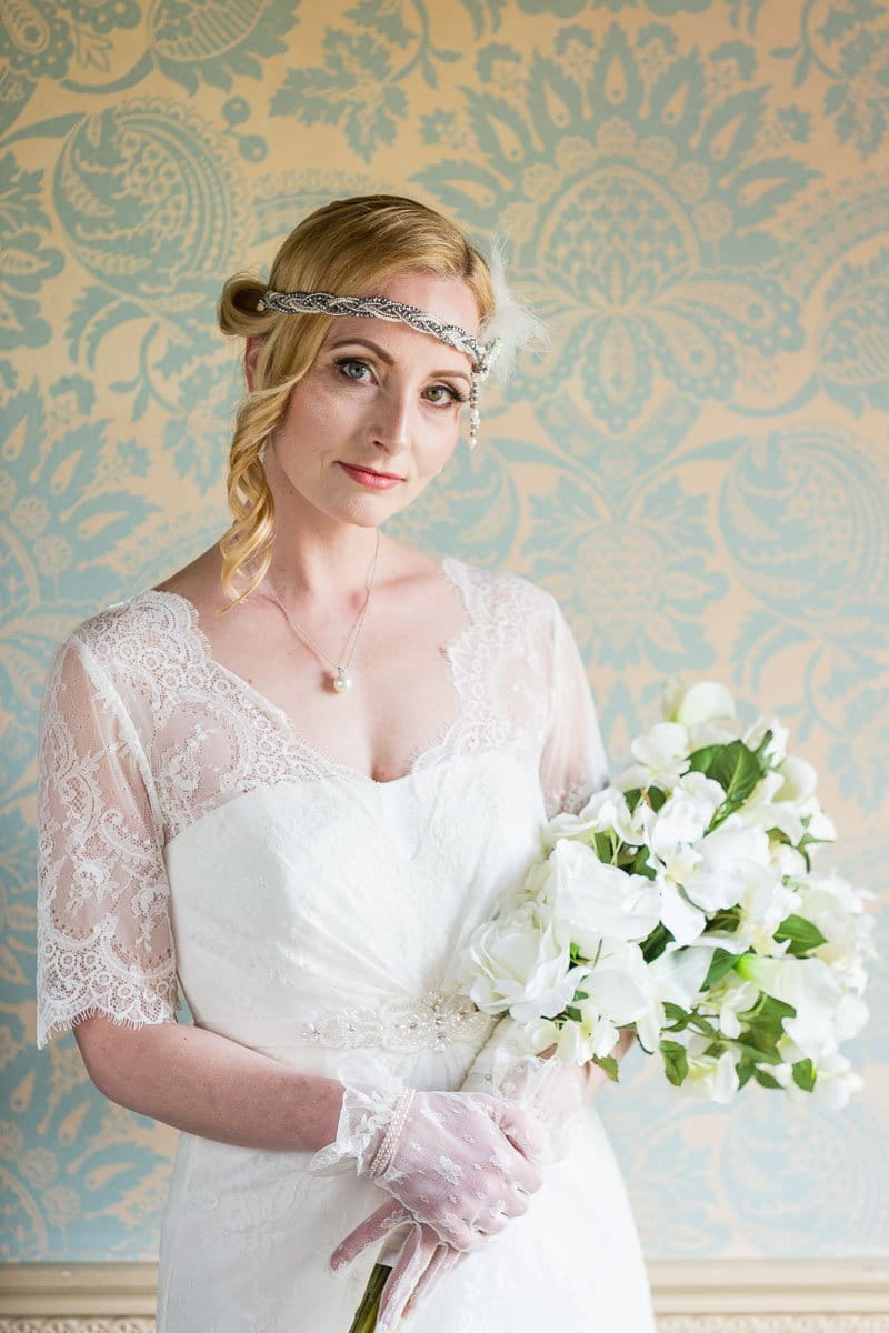 Vintage bride with headband holding white bouquet