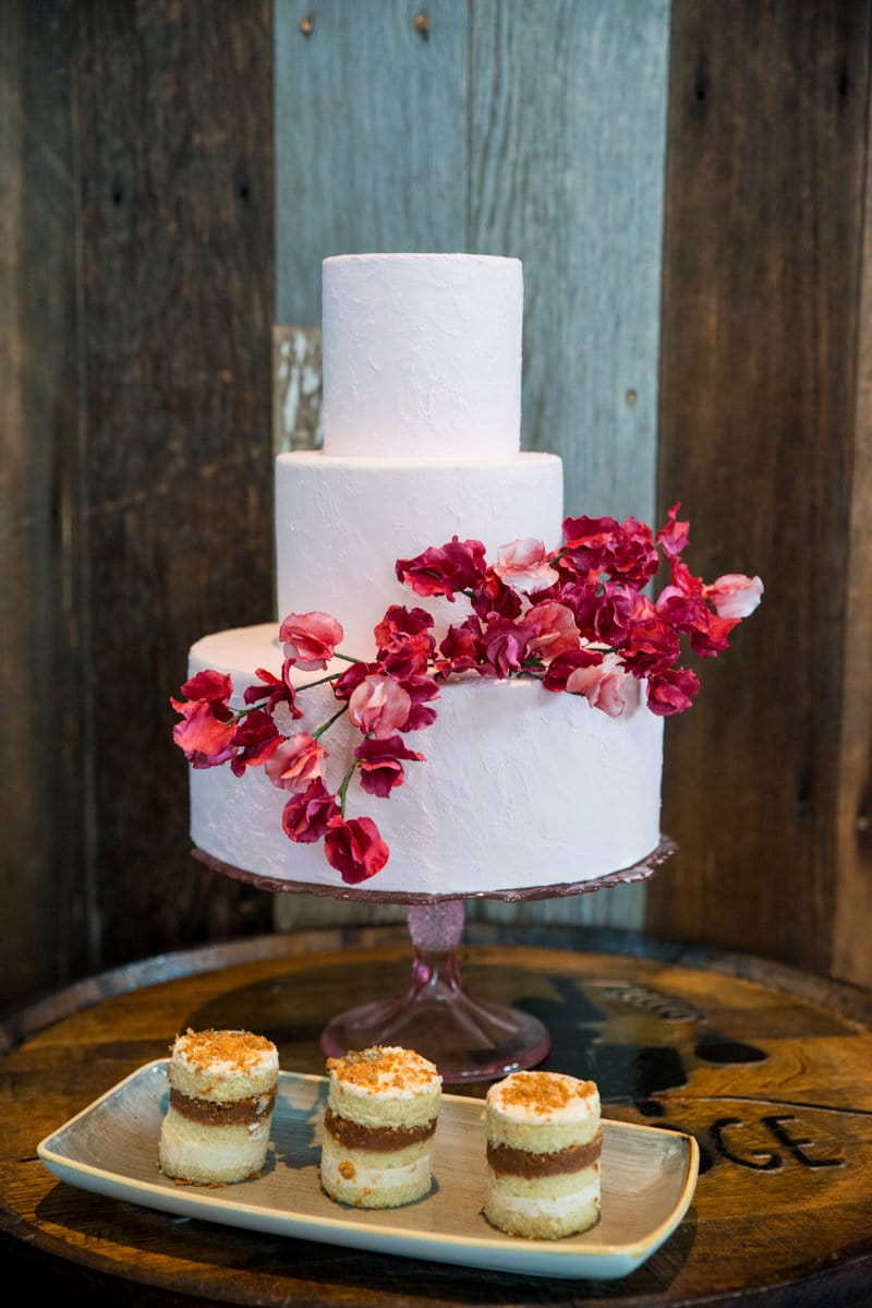 Plain white wedding cake decorated with red flowers