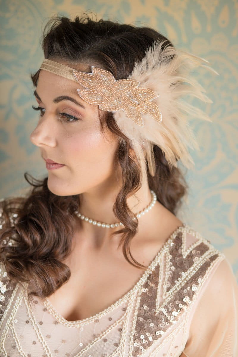 Bridesmaid wearing vintage style headband with feathers