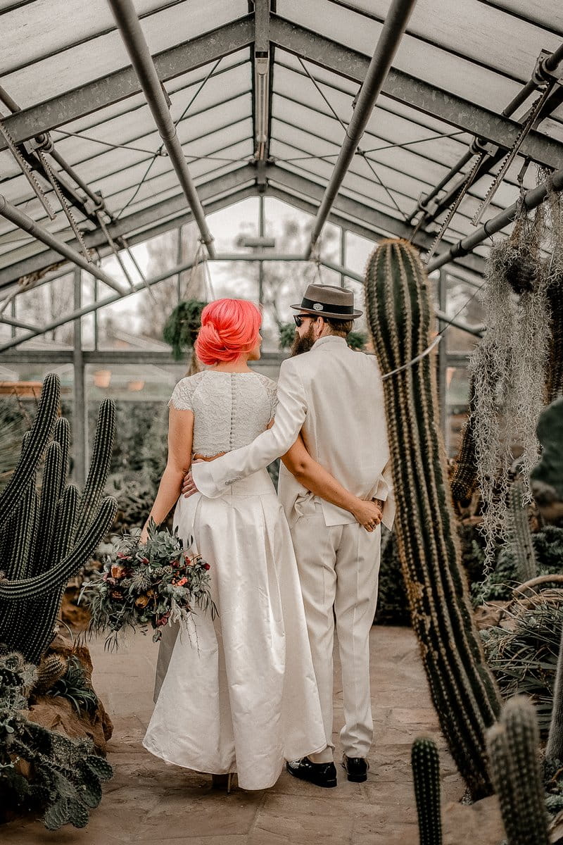 Bride and groom in greenhouse of cactuses