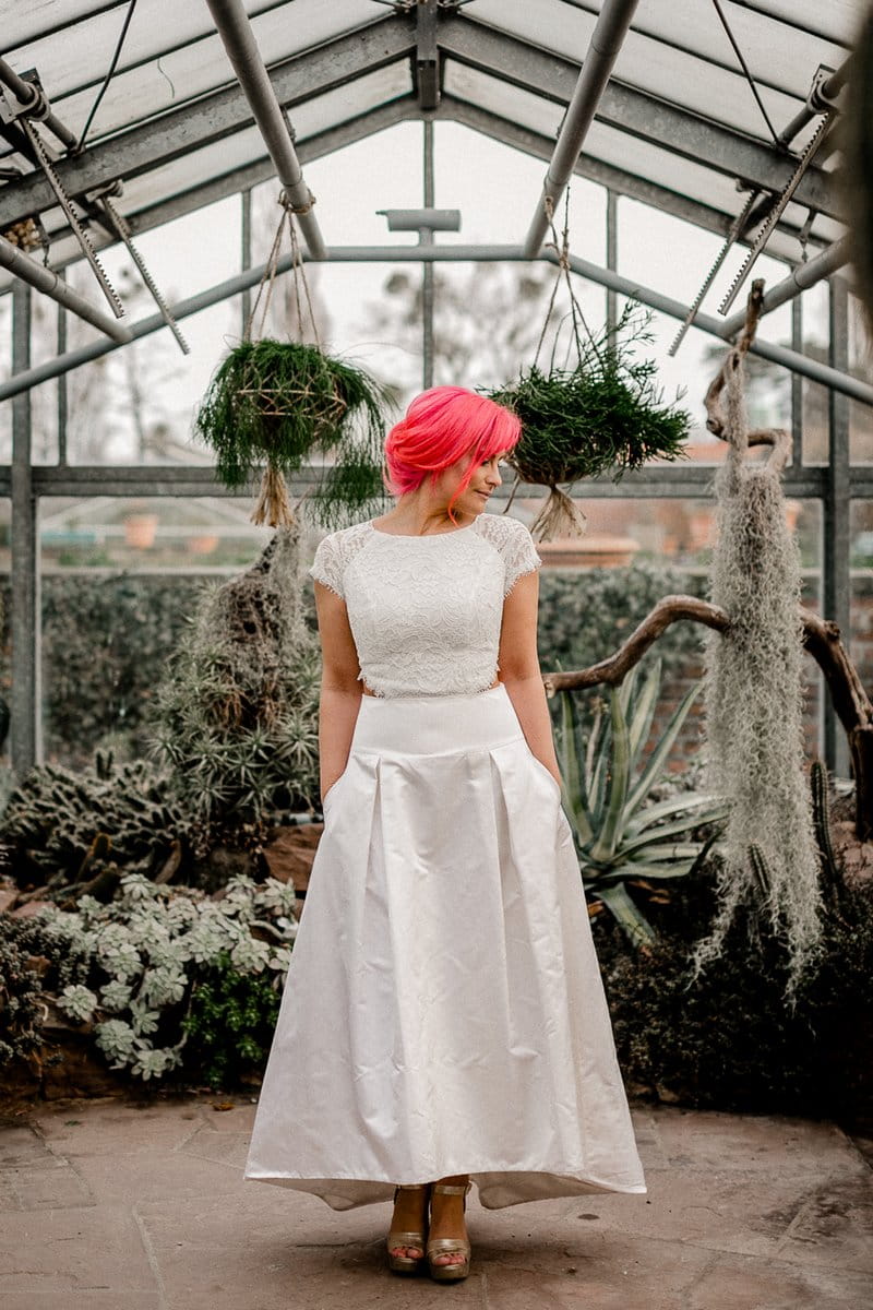 Bride with pink hair in greenhouse full of cactuses