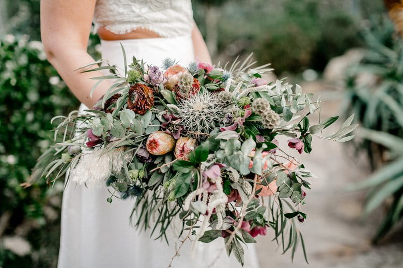 Bride holding wild bouquet