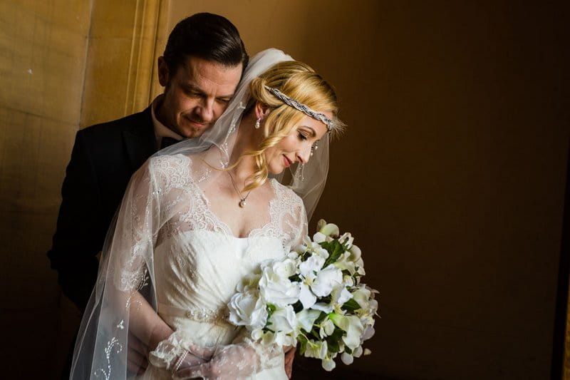 Groom standing behind vintage bride