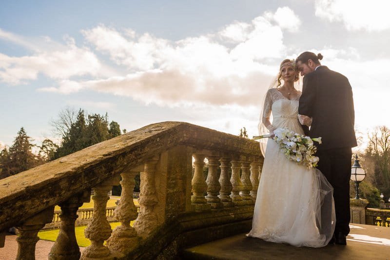 Bride and groom on steps of Heythrop Park