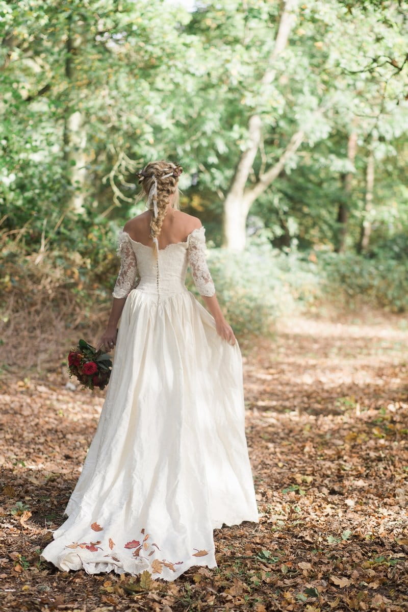 Bride walking through woodland