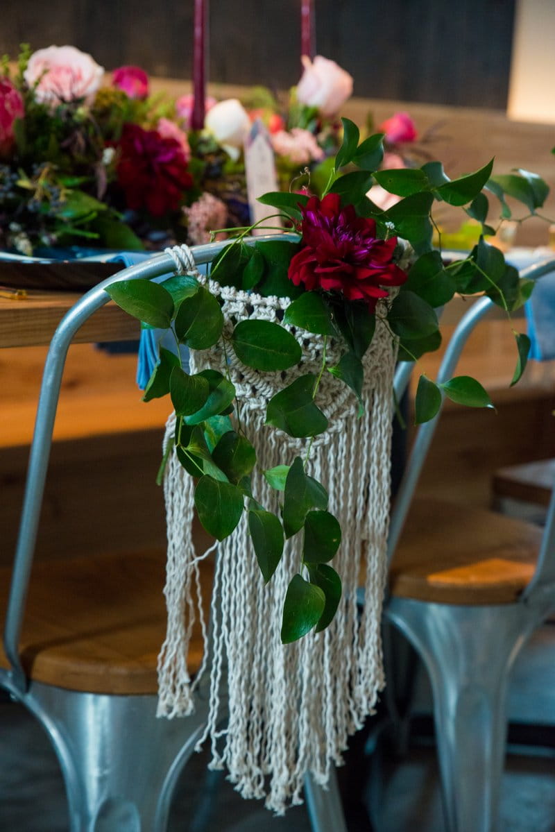 Macramé and flowers on back of wedding chair