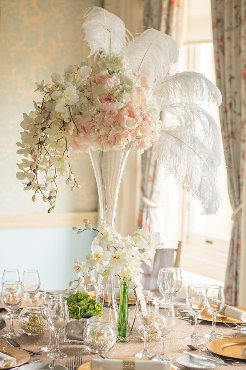 Floral wedding table centrepiece with feathers